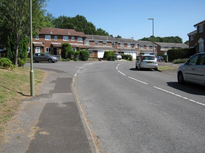 A street with cars parked on the side Description automatically generated with low confidence