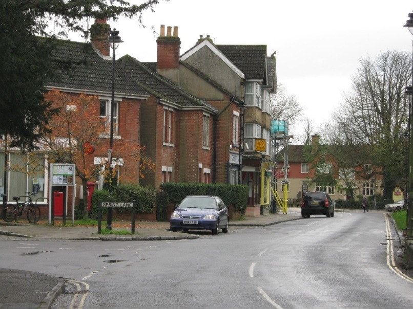 A street with cars parked on the side Description automatically generated with low confidence