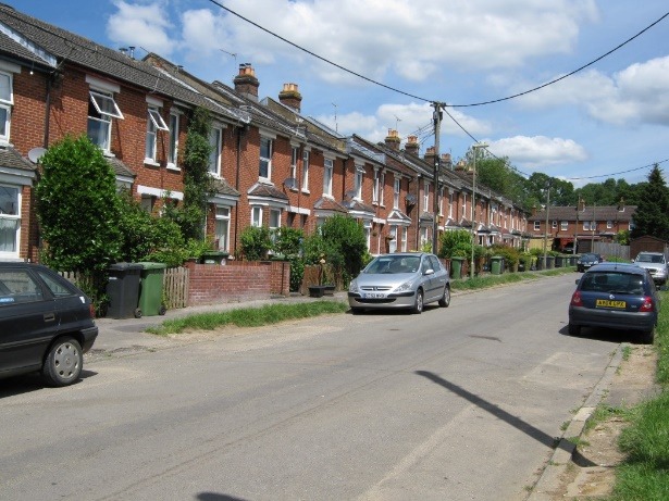 A street with cars parked on the side Description automatically generated with low confidence