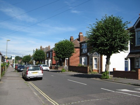 A street with houses along it Description automatically generated with medium confidence