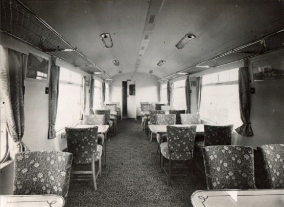 A train car with tables and chairs Description automatically generated with low confidence