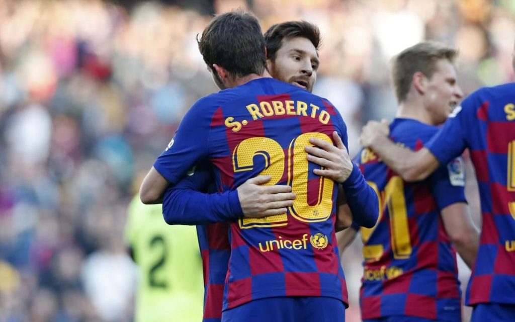 Roberto with Lionel Messi/ FC BARCELONA'S WEBSITE