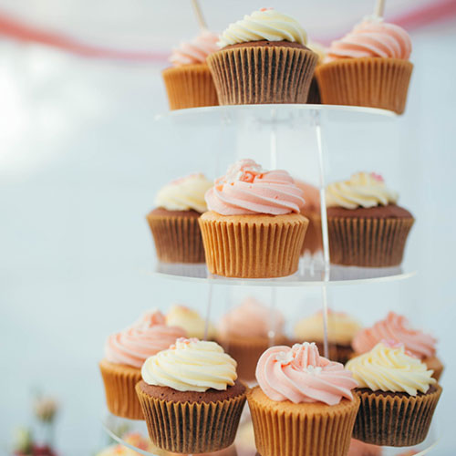 Wedding Cupcakes, presented on a tiered stand, iced in the bridal colours