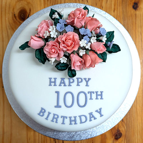 Regal iced cake dressed with a delicate, edible bouquet of flowers