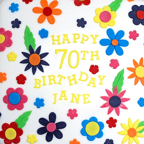 A Birthday message of "Happy 70th Birthday Jane" is surrounded by multicoloured flowers