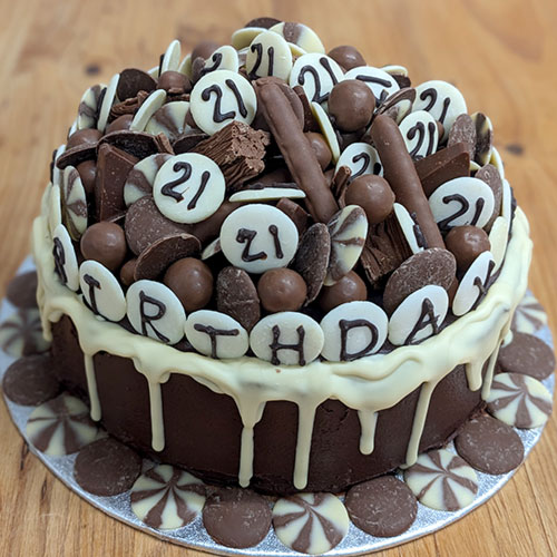 A 21st birthday cake for the chocaholic - covered in chocolate fingers, Malteasers and so many chocolate buttons!