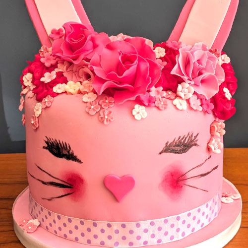 Cute pink cat cake, with edible flower headdress