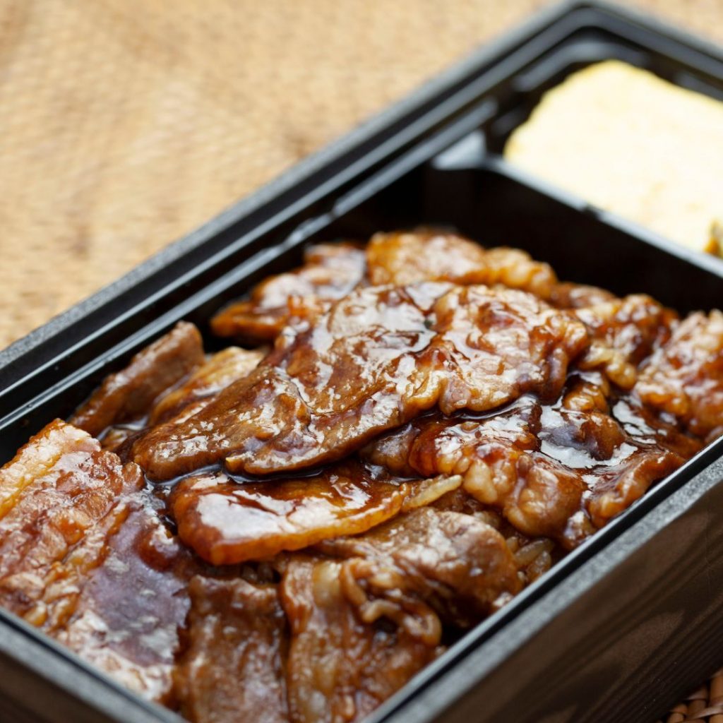 Yakuniku med sås i en traditionell japansk bento-låda Yakuniku med sås i en traditionell japansk bento-låda