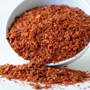 Bild på en skål med gochugaru – koreanskt chilipulver i en djupt röd färg med en mild hetta, som ofta används för att krydda kimchi