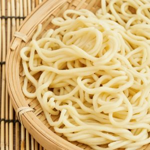En hög med färska ramen-nudlar, gulvita och elastiska, redo att kokas för en autentisk nudelsoppa. En hög med färska ramen-nudlar, gulvita och elastiska, redo att kokas för en autentisk nudelsoppa.