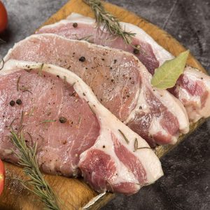 Råa fläskkotletter, gyllene och saftiga, färska i ljus rosa färg, perfekta för en hjärtlig måltid