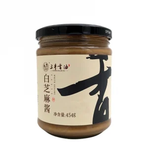 En burk vitsesampasta, en krämig och nötig pasta gjord av rostade vita sesamfrön, perfekt för såser och dressingar.