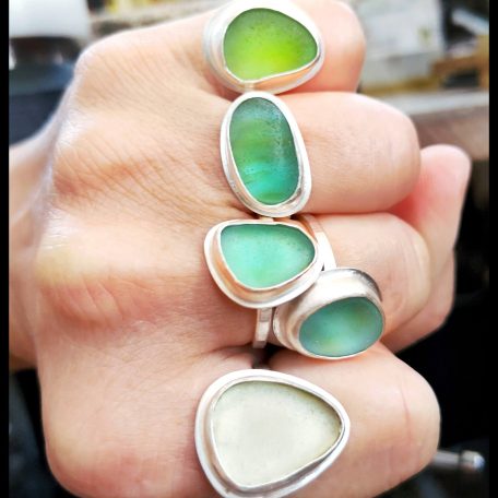 Sea glass rings on hand