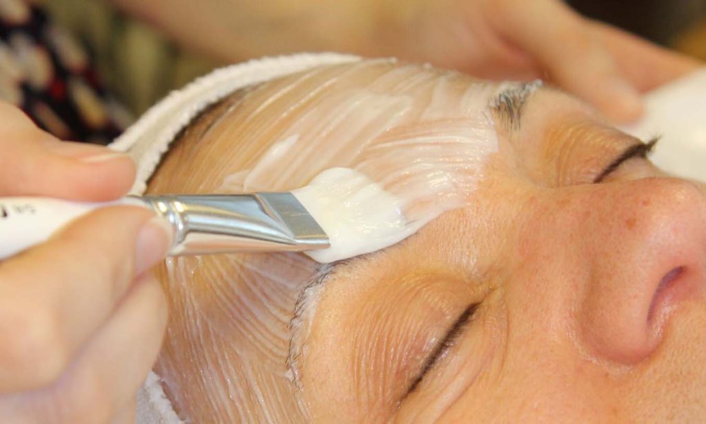 Environ Cool Peel serum being applied to the forehead of a woman