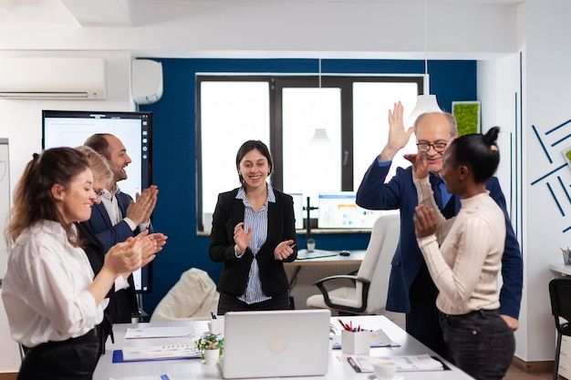 Premium Photo _ Happy overjoyed financial startup team standing clapping