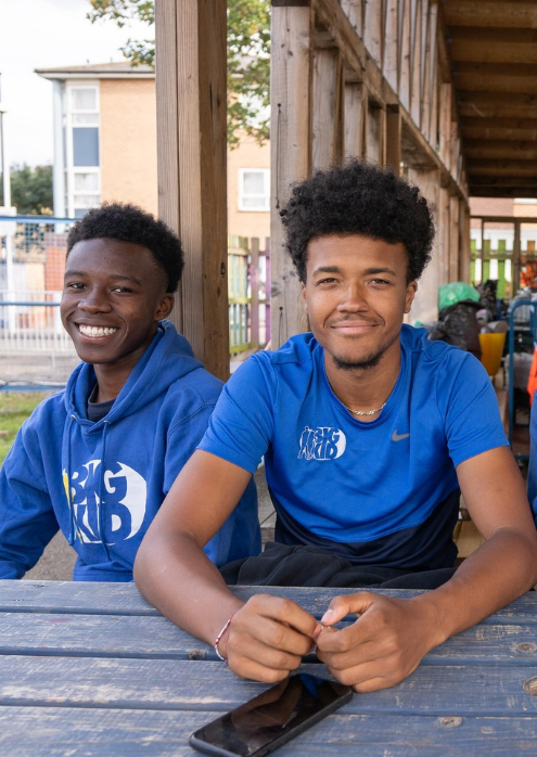 Two teenage boys smiling in the sunshine