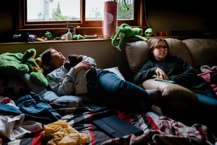 Sisters Kimberly Kobylecky (10) looks out the window as Janet Kobylecky (12) sits nearby in their shared bedroom in a Chicago suburb.