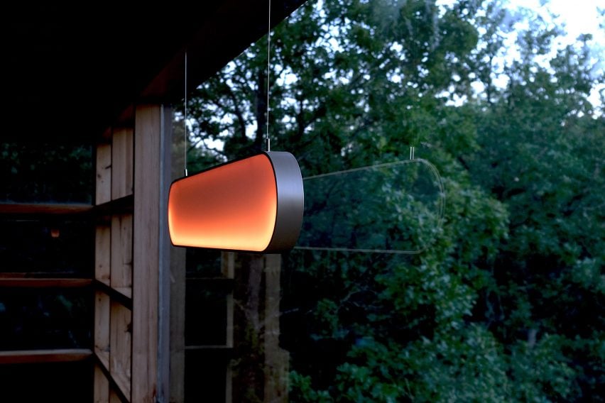 Glowing orange lamp hung in window