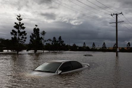 A car is submerged in flood waters on 31 March 2022, during the second bought of devastating floods to hit Lismore last year.