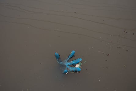 A rubber glove floating in floodwaters in Lismore.