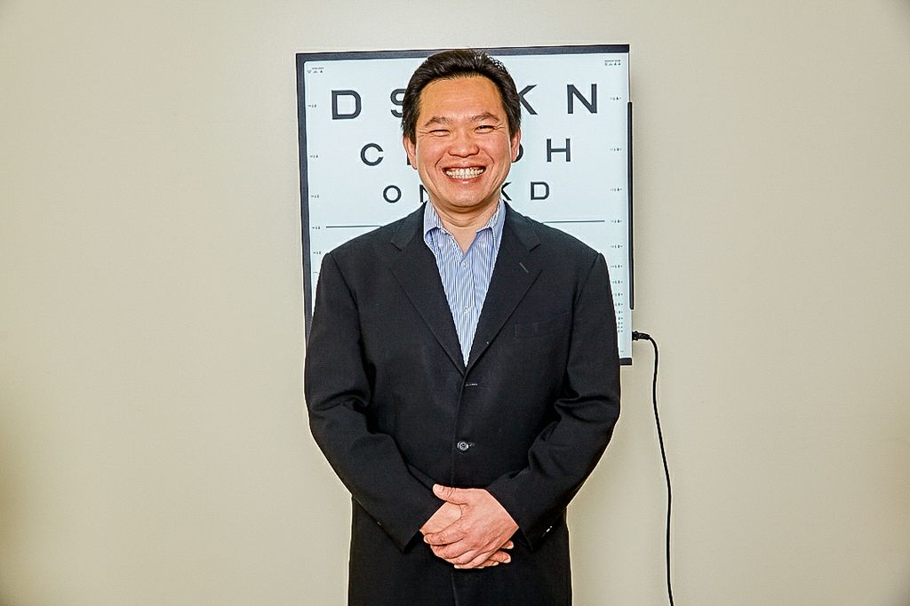 David Huang, M.D., Ph.D., in a suit standing near an eye esam chart. David Huang, M.D., Ph.D., is among 124 new members who have been elected to the academy, which is among the highest professional distinctions for engineers. He is believed to be the first OHSU representative to become an elected National Academy of Engineering member. (Courtesy of Scott Areman)