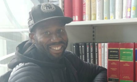 Ishuba Salmon sitting next to a bookcase