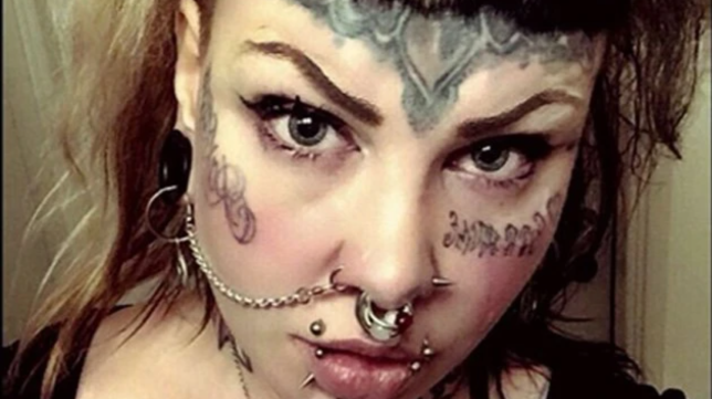 Lisa Strange showing off her face tattoos