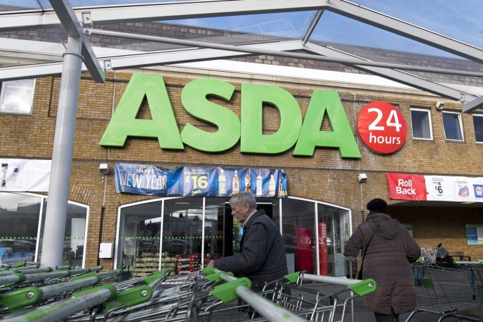 Customers arrive at a branch of Asda supermarket in south London