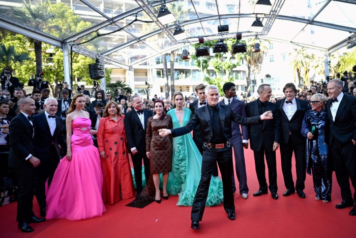 Australian director Baz Luhrmann, centre, arrives with cast members for the screening of the film ‘Elvis’ during the Cannes Film Festival in May last year. Warner Bros president and CEO David Zaslav is centre left
