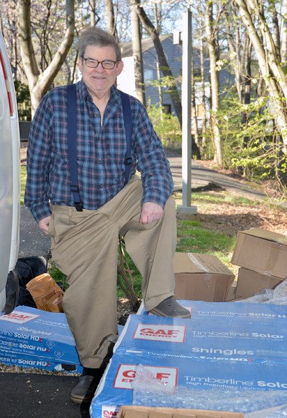 Jonathan Lockwood with a pallet of the Timberline shingles.