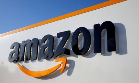 The Amazon logo on the side of a large warehouse