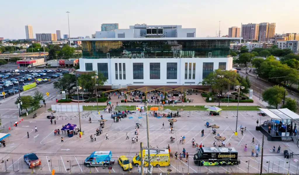 An aerial image of the Ion building and crowds gathered across an outdoor area with food trucks and a concert stage