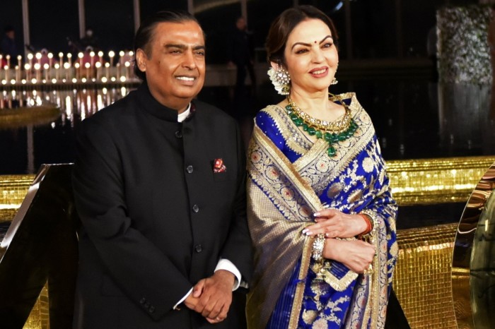 Mukesh Ambani and Nita Ambani pose for a photograph outside a cultural centre in Mumbai