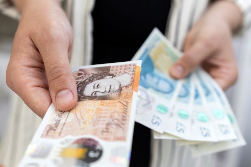 Sterling falls as cracks appear in Britain's job market