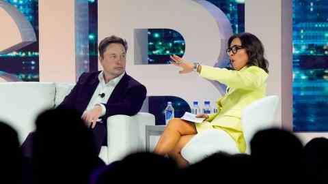 Elon Musk on stage with Linda Yaccarino at a marketing conference in Miami Beach in April