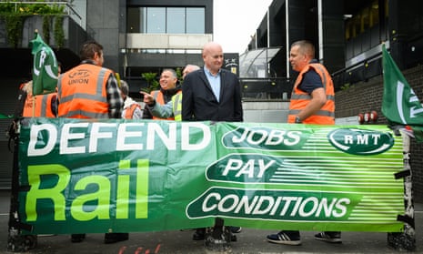 Secretary-General of the National Union of Rail, Maritime and Transport Workers (RMT) Mick Lynch with union members at a picket line outside Euston Station today