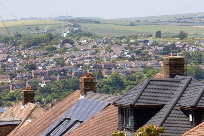 Solar panels on the rooftop of a residential house in a suburb of Brighton, UK