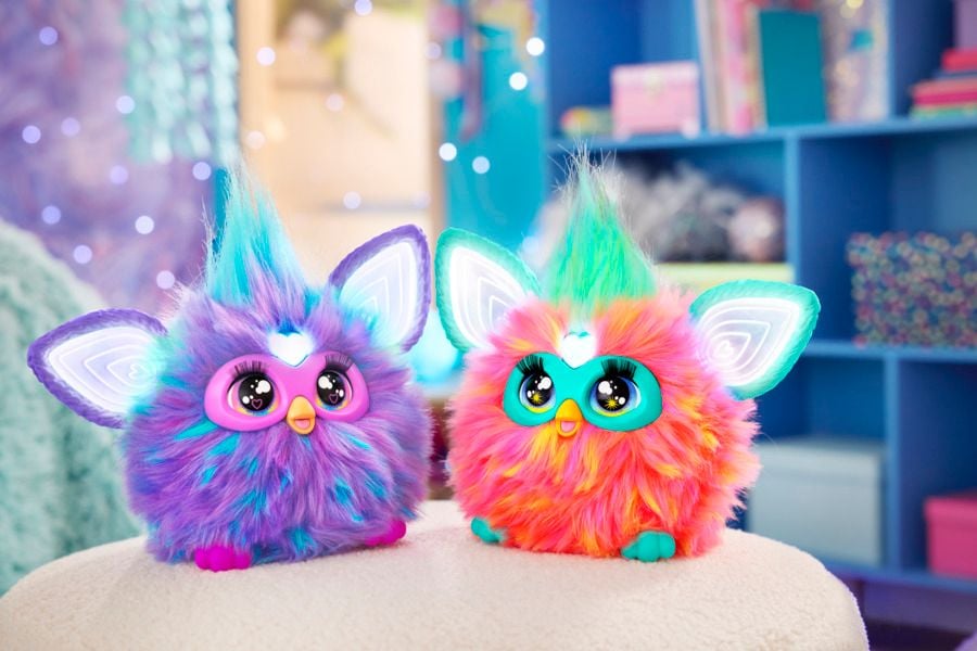 One purple and one coral-colored Furby.
