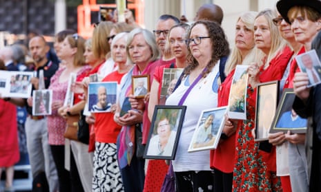 People holding pictures of loved ones lost during the pandemic outside the Covid inquiry at Dorland House in London today.
