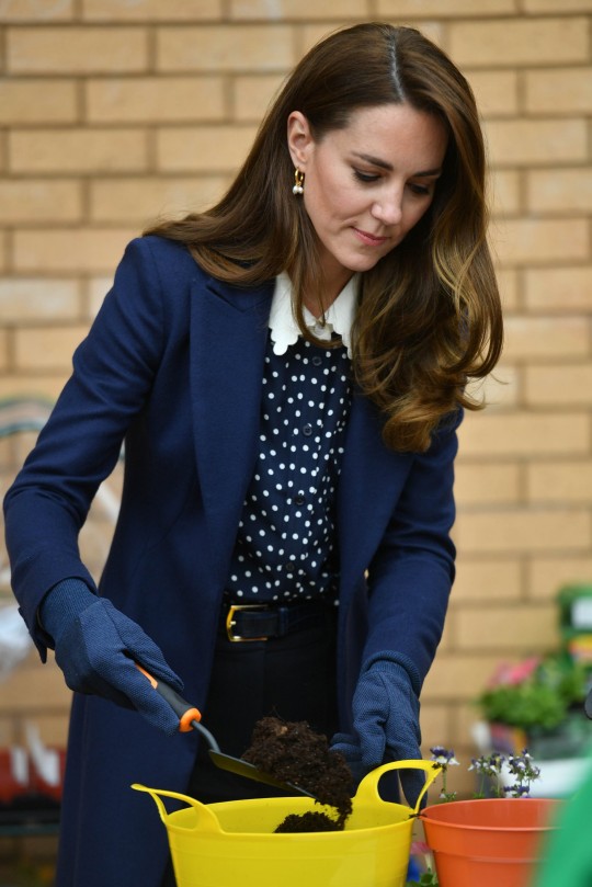 Catherine, Duchess of Cambridge pots a plant during a visit to The Way Youth Zone on May 13, 2021 in Wolverhampton, England.