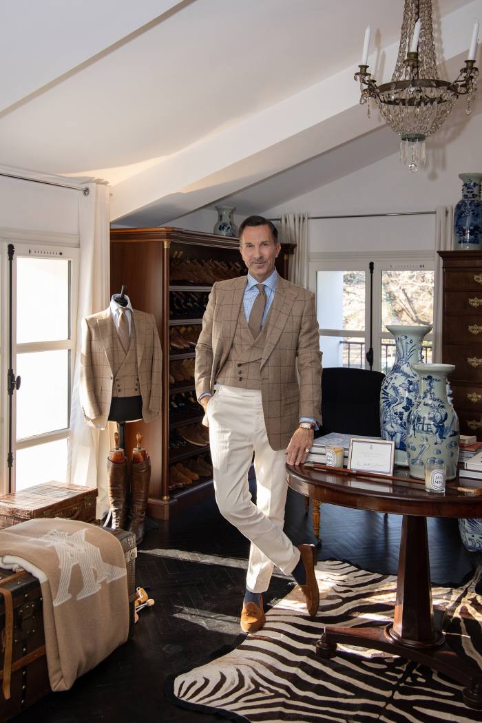 man standing in a dressing room wearing stylish clothes