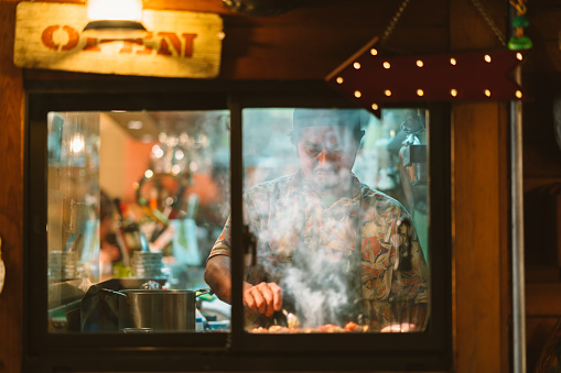Restaurant owner cooking for customers