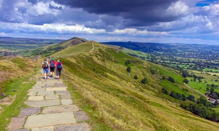 Hikers on the flagged footpath along the Great Ridge near Castleton Losehill Hall.