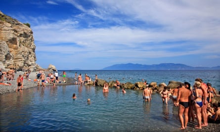 People enjoying a natural spa at the thermal springs of Therma (or Empros Thermes) beach, Kos island, Dodecanese, Greece.
