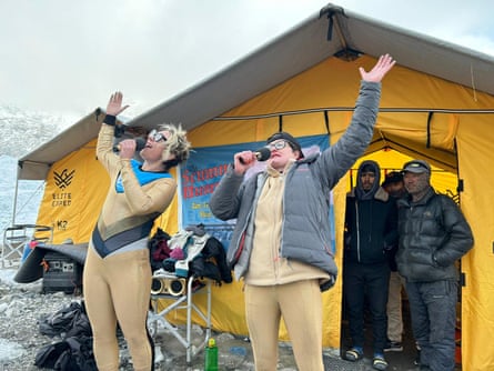 Thorn and Gibson performing in gold catsuits outside at tent at the Everest base camp