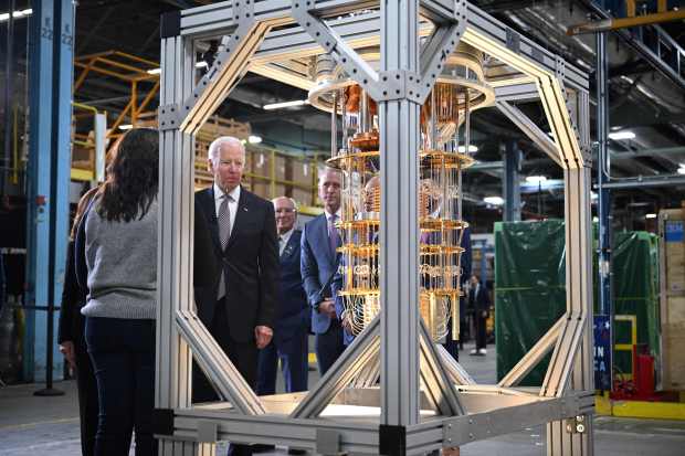 President Joe Biden looks at a quantum computer as he tours an IBM facility on Oct. 6, 2022. IBM hosted Biden to celebrate the announcement of a $20 billion investment in semiconductors, quantum computing and other cutting-edge technology. (Photo by MANDEL NGAN / AFP) (Photo by MANDEL NGAN/AFP via Getty Images)