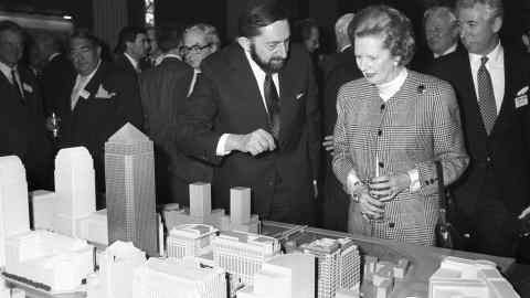 Margaret Thatcher and men in suits looks at a model of the development