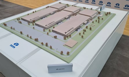 A photo of an example of a battery module in front of a scale model of the planned Tata battery gigafactory, which is expected to be built in Somerset.