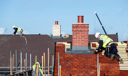 Construction workers at a Taylor Wimpey housing estate in Aylesbury, Britain.