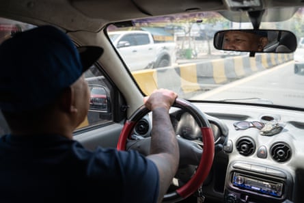 Chandara Tep drives a car around Phnom Penh, Cambodia.